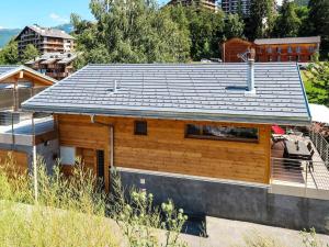 a house with a metal roof on top of it at Chalet Les Penguins by Interhome in Nendaz