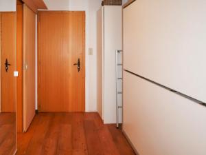 an empty hallway with a door and wooden floors at Studio Bouleaux B1 by Interhome in Nendaz