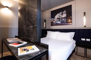 a hotel room with a bed and a desk at Heart Hotel Milano in Milan +16 photos