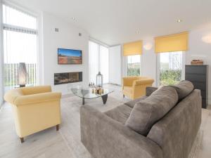 a living room with a couch and two chairs at Holiday Home Water Resort Oosterschelde - nr- 47A by Interhome in Wemeldinge +15 photos