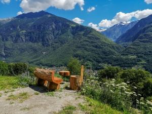 a bench on a hill with mountains in the background at Holiday Home Rustico Rudico by Interhome in Semione