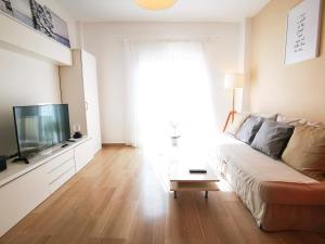 uma sala de estar com um sofá e uma televisão de ecrã plano em Fuengirola Centro Histórico. A 200 m de la playa em Fuengirola