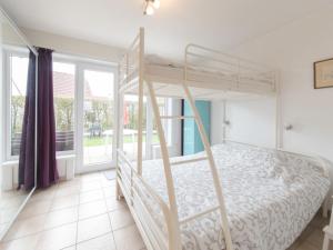 a bedroom with a bunk bed and a window at Studio Siena by Interhome in De Haan