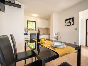a kitchen and dining room with a table and chairs at Holiday Home Erminia by Interhome in Lovran +18 photos