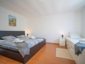 a bedroom with two beds with towels on them at Holiday Home Erminia by Interhome in Lovran