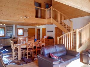 a living room with a couch and a dining room at Chalet Banksia by Interhome in Ovronnaz
