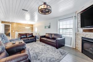a living room with leather furniture and a fireplace at Sunshine's Holiday in Panama City Beach