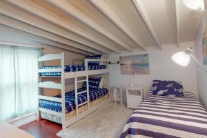 a bedroom with a bed and bunk beds in it at Old Orchard Beach House in Old Orchard Beach