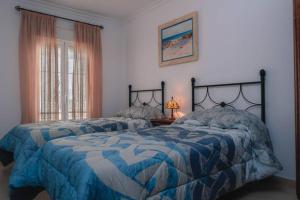 Dos camas una al lado de la otra en un dormitorio. en Casa Pepita Feria, en Valverde del Camino