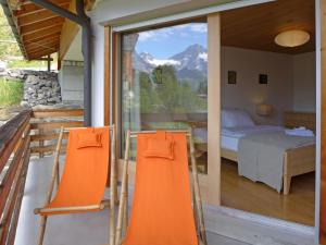 a bedroom with a view of a bed and a window at Apartment Gloria Süd by Interhome in Mürren