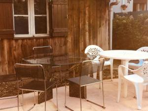 a patio with chairs and a table and a table and chairs at Maison spacieuse et accueillante à Cirey-sur-Vezouze + Jardin in Cirey-sur-Vezouze