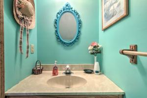 a bathroom with a sink and a mirror at Chincoteague Townhome with Pony Views from Deck! in Chincoteague