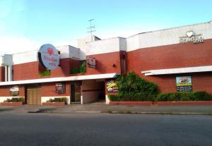 a building with a sign on the side of it at Studio Motel (Adult Only) in Santos