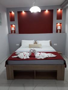 a bedroom with a bed with towels on it at Panorama Apartments in Prinos