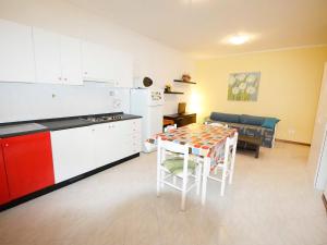 a kitchen with a table and a dining room at Apartment Troiani by Interhome in Porto dʼAscoli