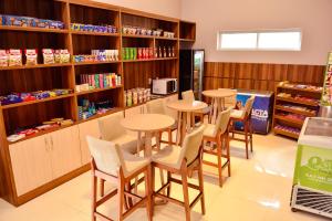 a restaurant with tables and chairs in a store at Forte Express in Macapá +30 photos