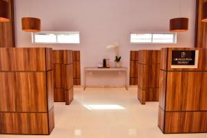 a row of wooden stalls in a room at Forte Express in Macapá