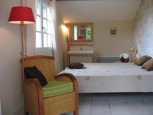 a bedroom with a bed and a table and chairs at Bordo Basso in Laugnac