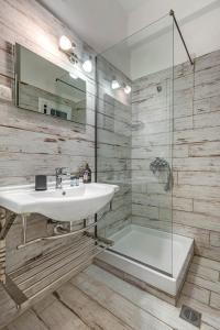 a bathroom with a sink and a shower at Eros Beach Hotel in Benitses