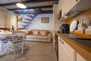 a kitchen and living room with a couch and a table at Vanilla in Izola