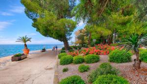 a park next to the water with flowers and trees at Vanilla in Izola