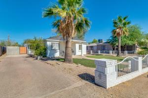 a house with a palm tree and a fence at ULTRA COZY CASITA BY DTWN PHX in Phoenix