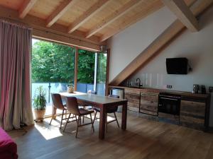 a kitchen and dining room with a table and chairs at Ferienwohnungen und Zimmer in Reutlingen-Gönningen in Reutlingen