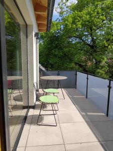 een patio met een tafel en stoelen op een balkon bij Ferienwohnungen und Zimmer in Reutlingen-Gönningen in Reutlingen