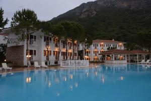 a large swimming pool in front of a hotel at White Hotel in Oludeniz