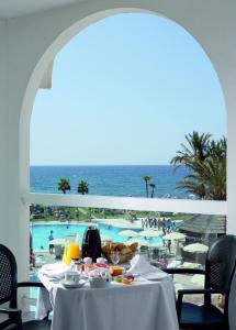 a dining room with a view of the ocean at Ona Marinas de Nerja Spa Resort in Nerja