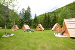 a group of tents in a field with grass at Camp Korita in Soča