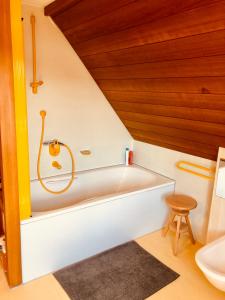 a bath tub in a bathroom with a wooden ceiling at Gemütliche Fewo Nähe Hachenburg, Bad Marienberg in Langenbach bei Kirburg