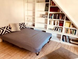 a bed in a room with a book shelf at Gemütliche Fewo Nähe Hachenburg, Bad Marienberg in Langenbach bei Kirburg