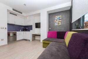 a living room with a couch and a kitchen at Villa Steffi in Baška Voda