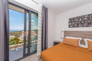 a bedroom with a bed and a large window at Villa Steffi in Baška Voda +110 photos