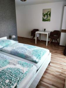 1 dormitorio con 2 camas y mesa en B & B Seeblick Krippenstein en Obertraun