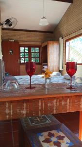 dos copas de vino sentadas en un mostrador en una cocina en Espaço Puri, en Divino de São Lourenço