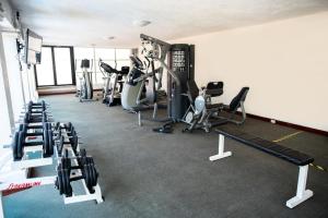 a gym with several treadmills and cardio machines at Hosteria Las Quintas Hotel Restaurante Bar in Cuernavaca