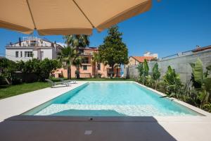 a swimming pool in the backyard of a house at Villa Rosa Residence in Santa Maria di Castellabate