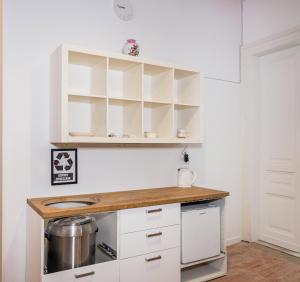 a kitchen with white cabinets and a counter top at Krakus in Kraków