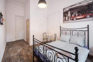 a bedroom with a bed and a picture of a car on the wall at Krakus in Kraków