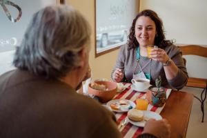 two women sitting at a table eating breakfast at Aires de Cafayate in Cafayate