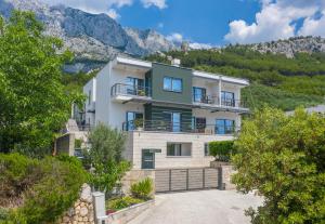 an image of a house with mountains in the background at Villa Steffi in Baška Voda