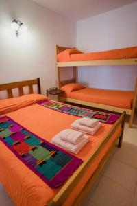 a bedroom with two bunk beds and two towels at Aires de Cafayate in Cafayate
