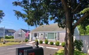 a house with a flag in front of it at Kingfisher Oceanside in Dennis Port