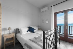 a bedroom with a bed with a view of the ocean at Kalokerino in Olympiada