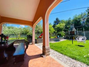 an enclosed patio with a view of a yard at Apartma Mija-Dekani in Dekani