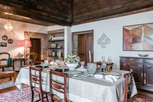 a dining room with a table with a white table cloth at Private Nature Villa with Saltwater Pool in North Portugal in Cabeceiras de Basto