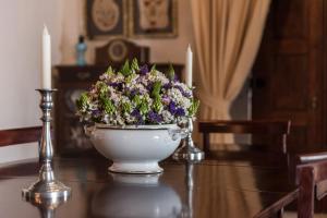 a flower arrangement in a white bowl on a table at Private Nature Villa with Saltwater Pool in North Portugal in Cabeceiras de Basto
