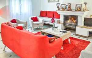 ソー・ドゥ・ヴォクリューズにあるStunning Home In Saint Trinit With 2 Bedroomsのリビングルーム(赤い家具、暖炉付)